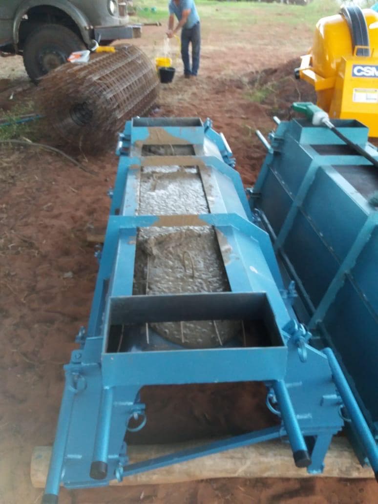 The feed bunk mold filled with cast concrete, forming a completed bunk.