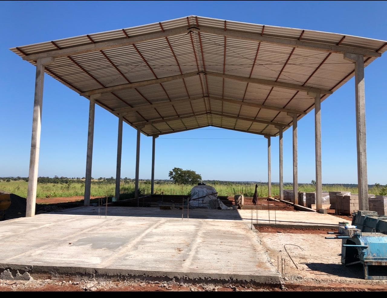 Completed covered cattle handling facility with a poured concrete floor.